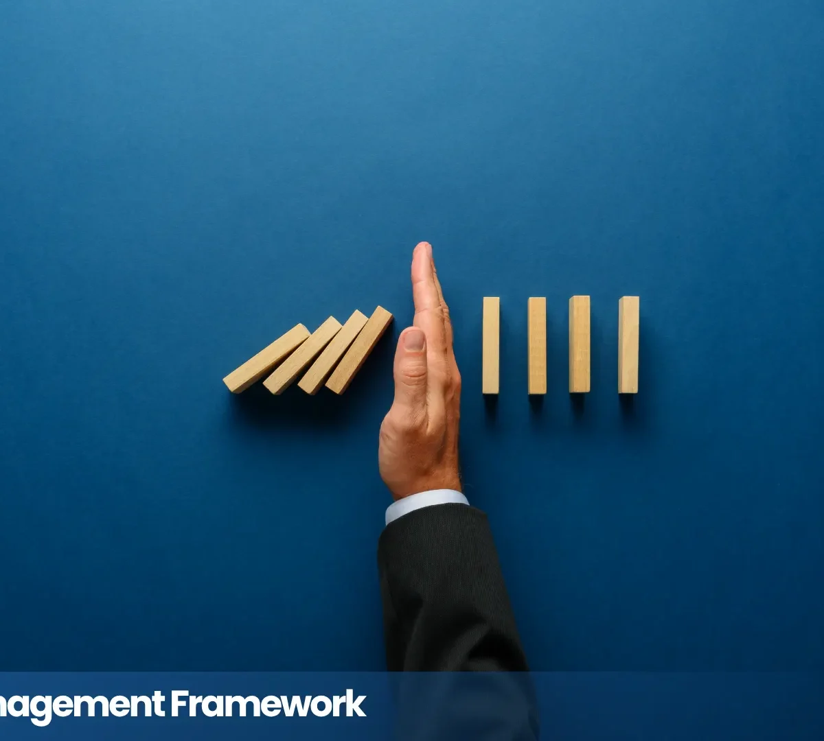 Data risk management framework illustrated by a hand stopping falling wooden blocks.